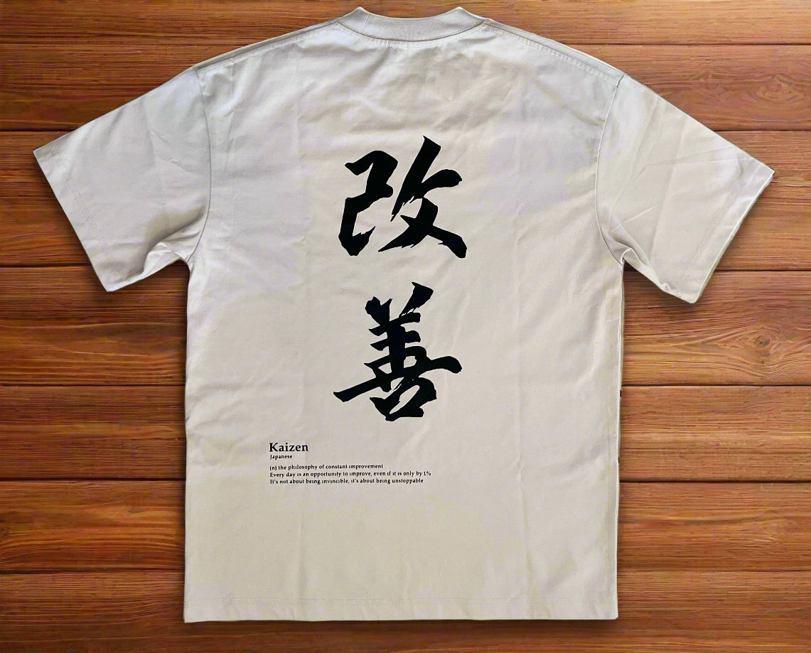 White t-shirt with black text on a tiled floor
